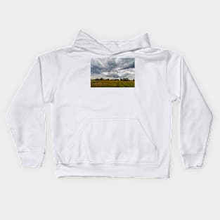 Stormy clouds over meadow Kids Hoodie